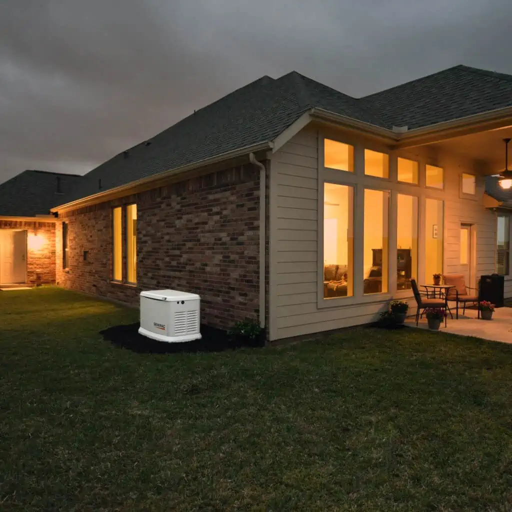 A large house with a lawn in the evening.